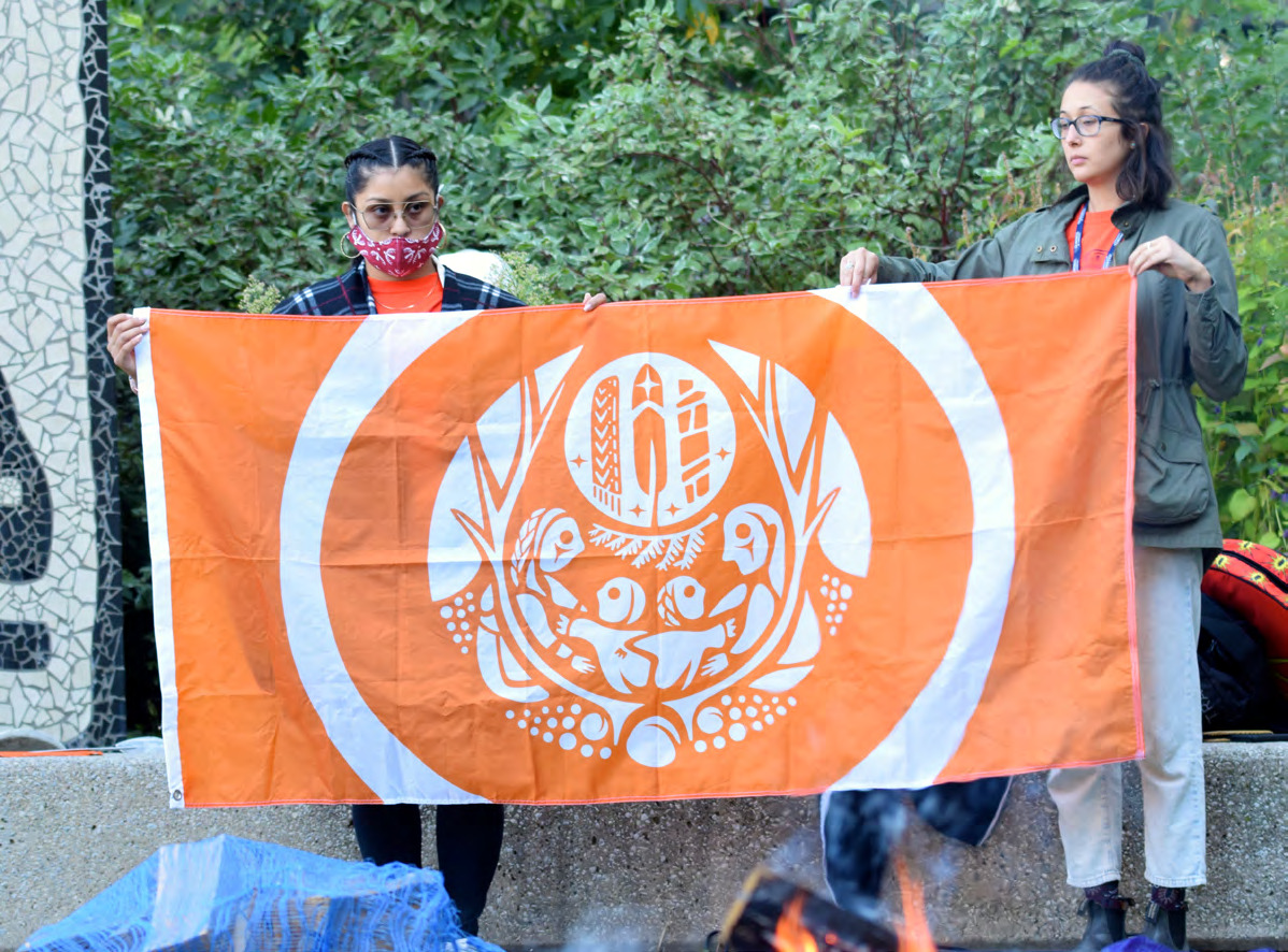 Indigenous Health flag held by members of UHN's community.
