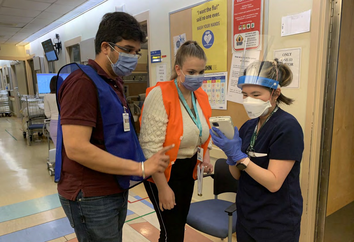 An advanced user assists a nurse on the Transplant Unit at Toronto General Hospital.
